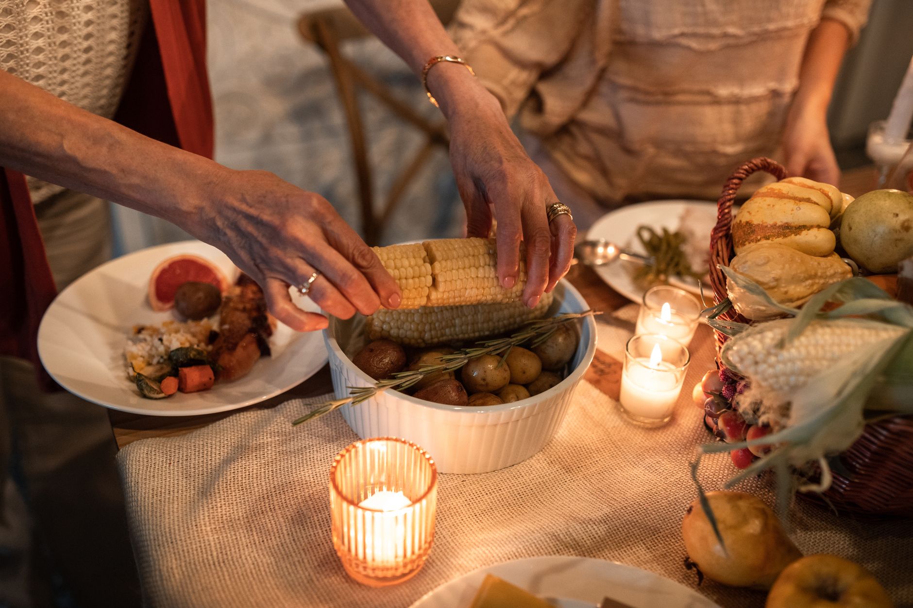 Long harvest table set outdoors with seasonal dishes and linen