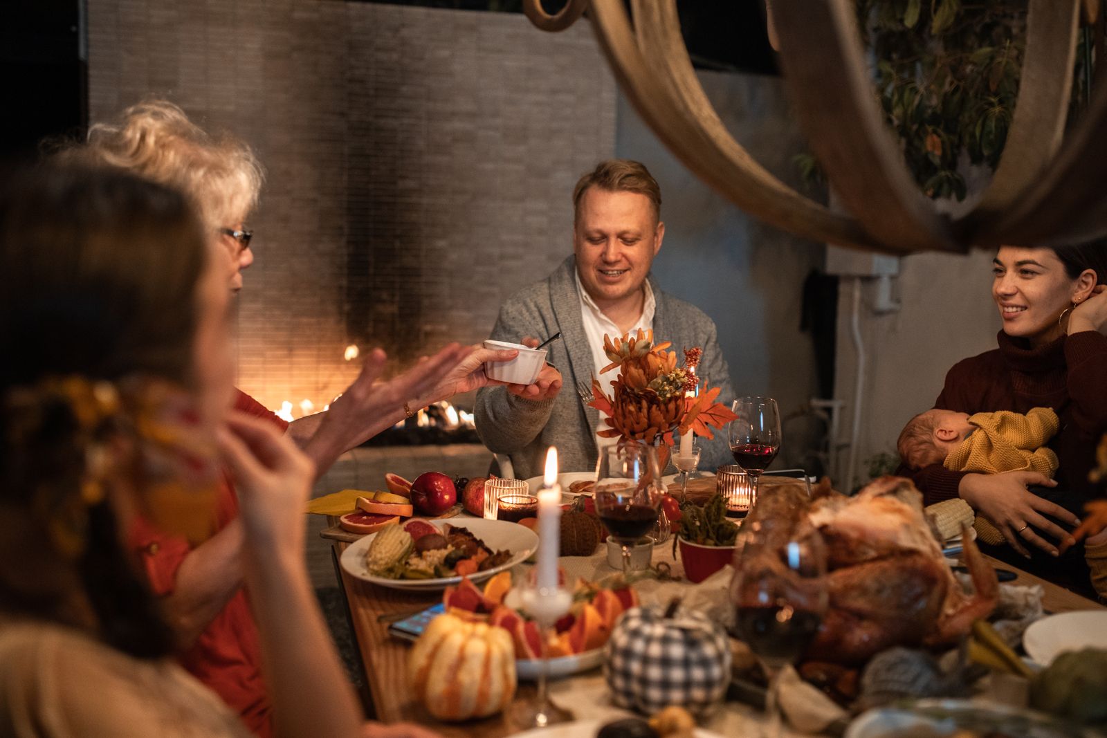 Family gathered around a festive Thanksgiving dinner table