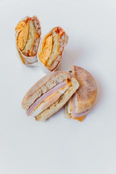 Close-up of mouth-watering breakfast sandwiches with ham, cheese, and egg.