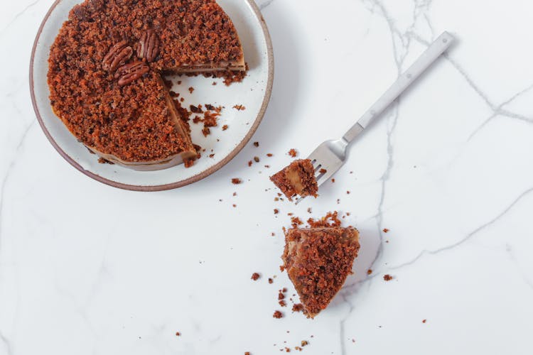 Sliced Pecan Cake On White Ceramic Plate