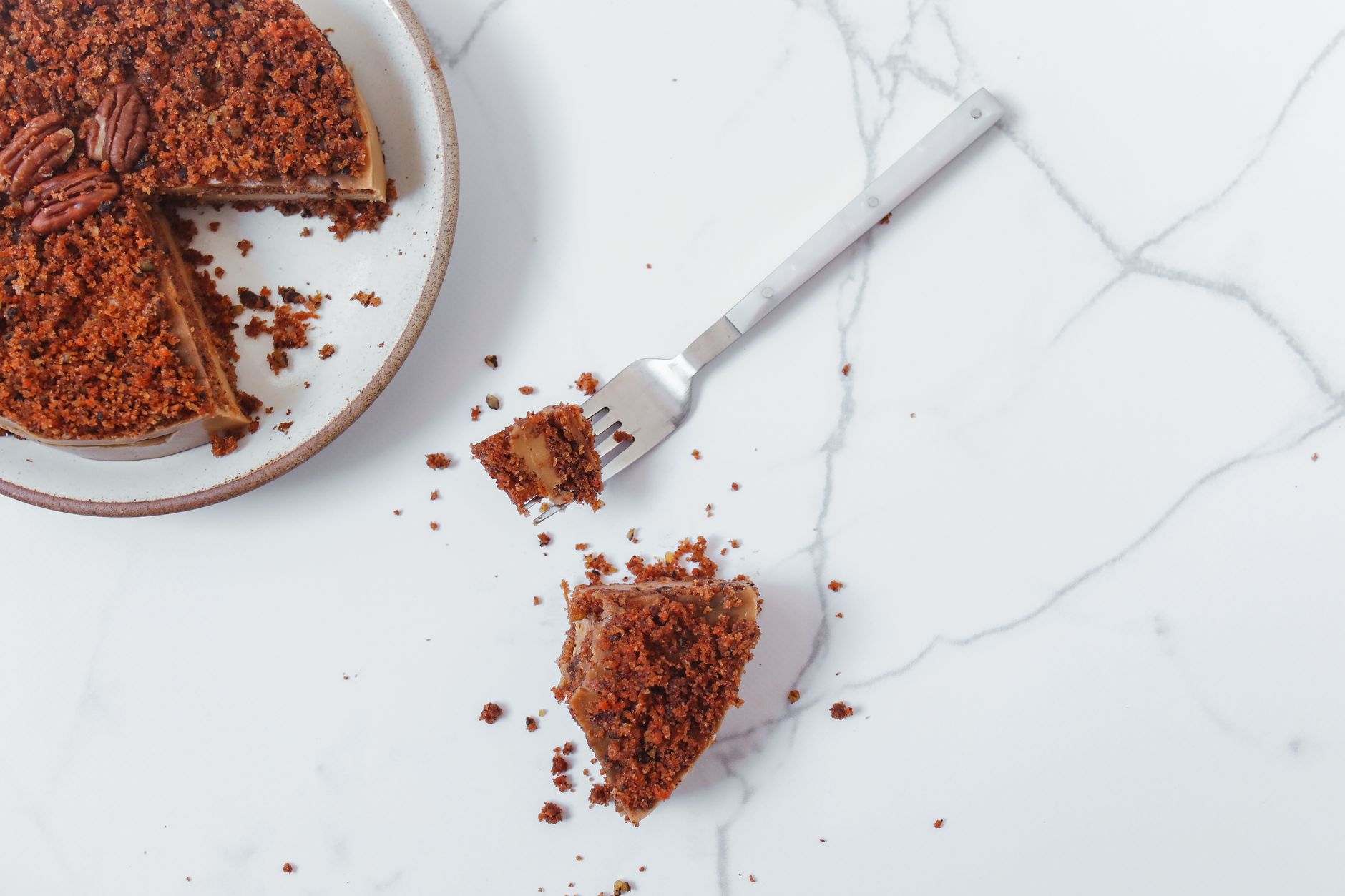 Chocoflan slice on a plate with caramel dripping
