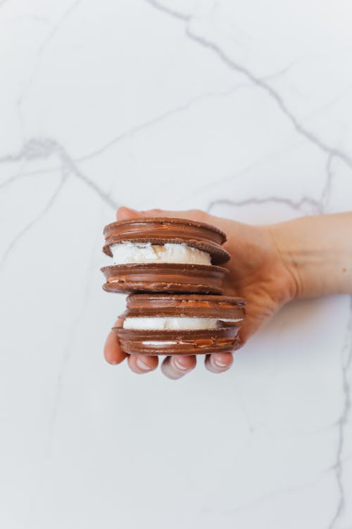 Free Person Holding Two Chocolate Pies Stock Photo