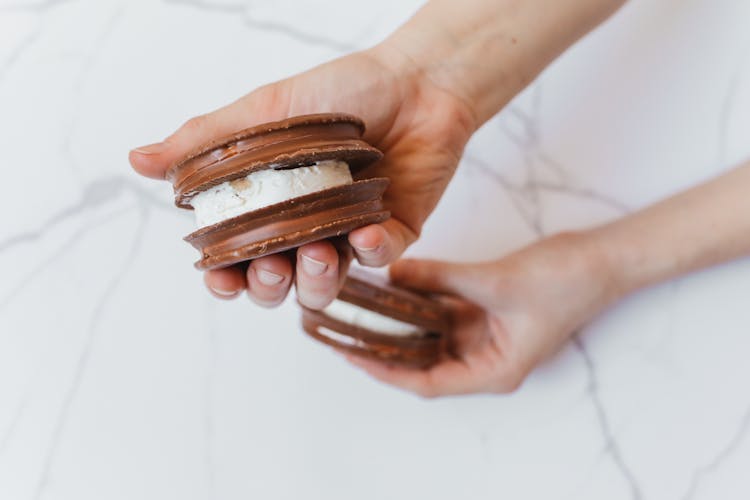 A Person Holding Chocolate Sandwich Cookies