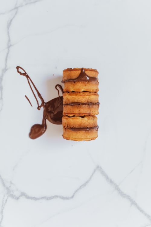 Free A stack of homemade Belgian waffles topped with rich chocolate on a marble surface. Stock Photo