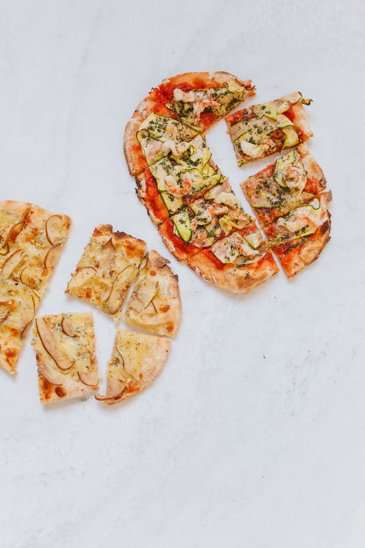 Pizzas On White Table