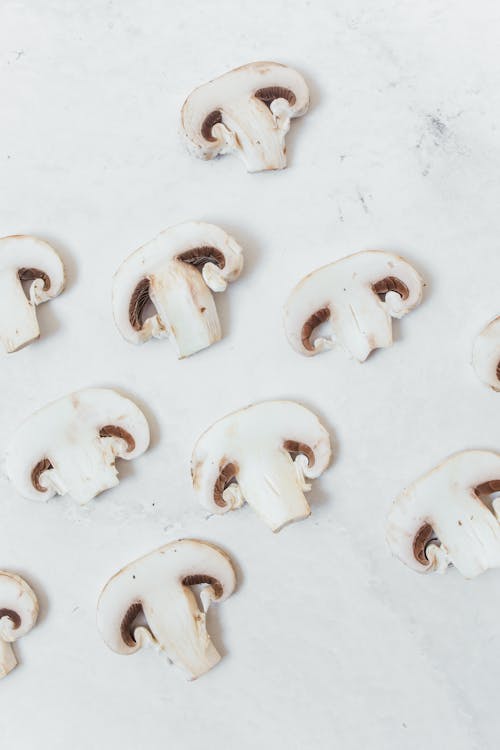 Free Sliced Mushrooms on White Surface Stock Photo