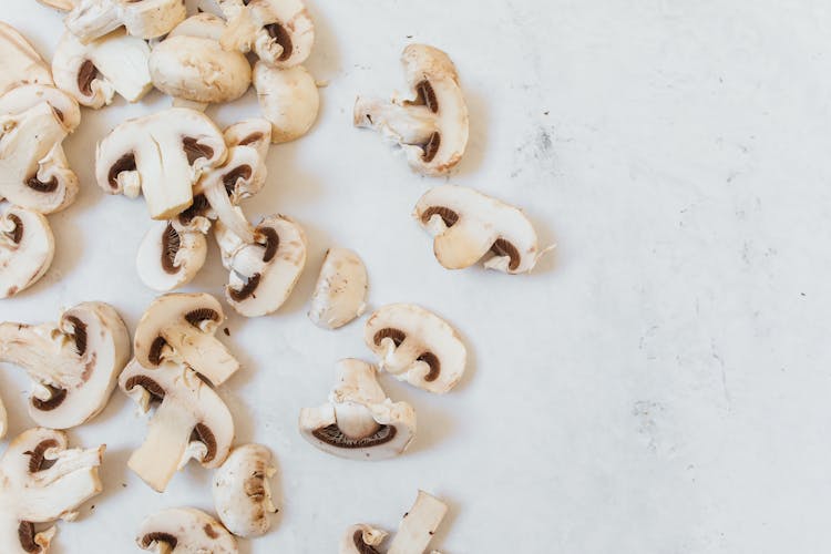 Champignon Mushrooms On A White Surface