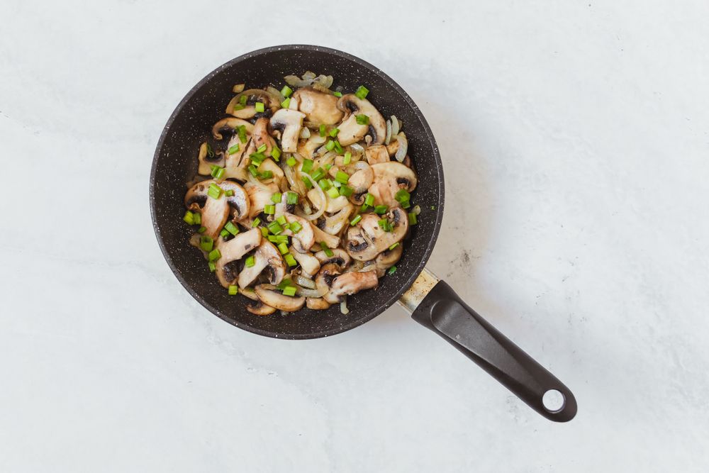 Chopped onion and peppers softening in a skillet, photographed from above — Polina Tankilevitch on Pexels