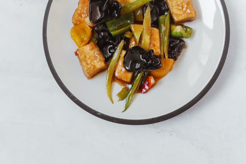 Stir Fry Vegetables and Tofu on a Ceramic Plate