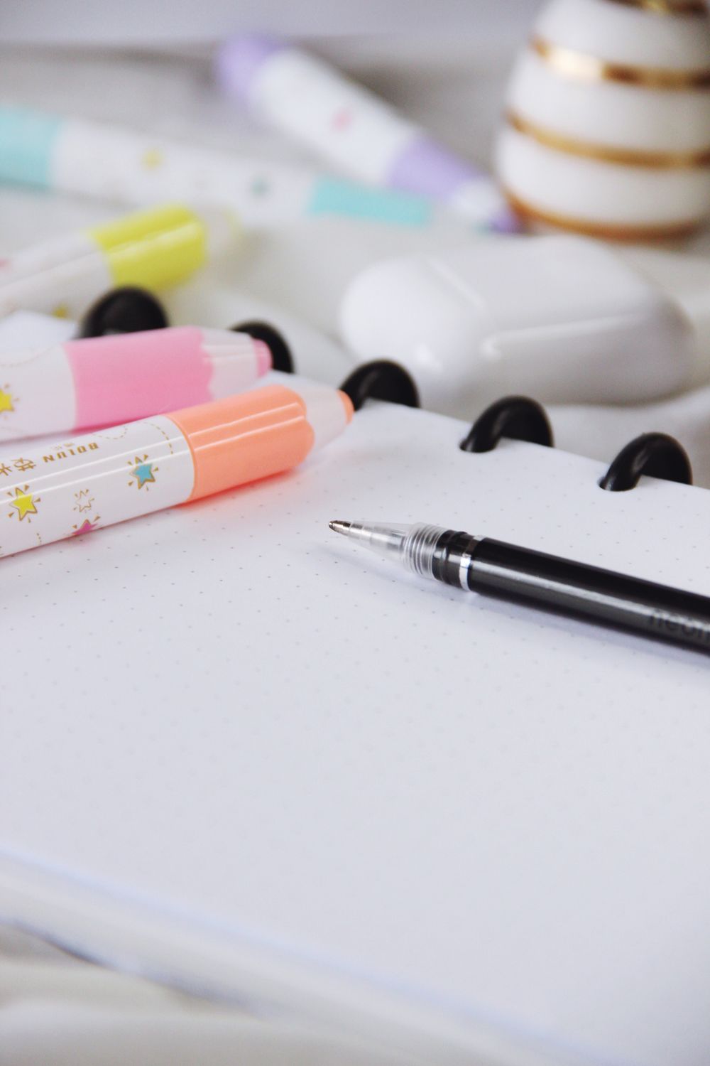 Opened copybook with pen and highlighters ยท Free Stock Photo