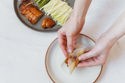 Free Wrapping Sliced Peking Duck in Crepes Stock Photo