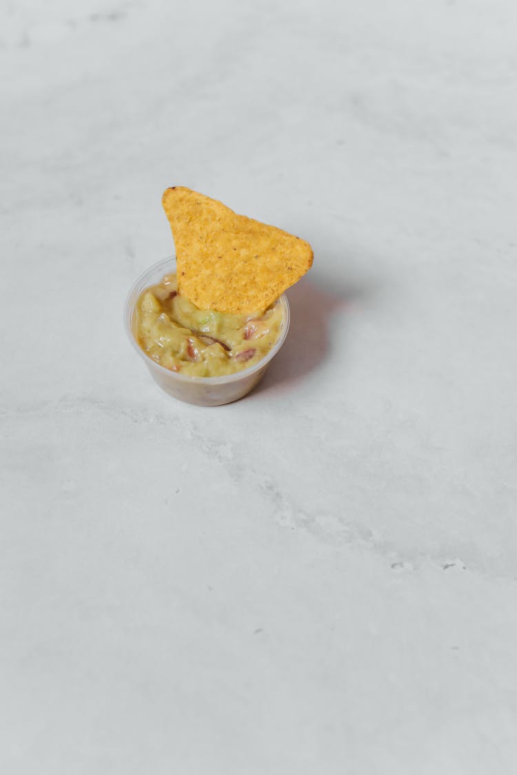A Nacho Chips In A Dipping Sauce