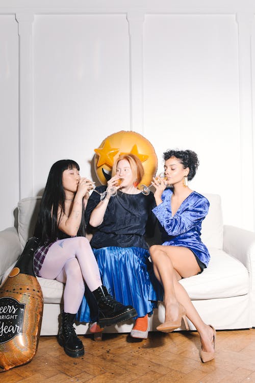 Three Women Drinking Champagne on New Years Eve