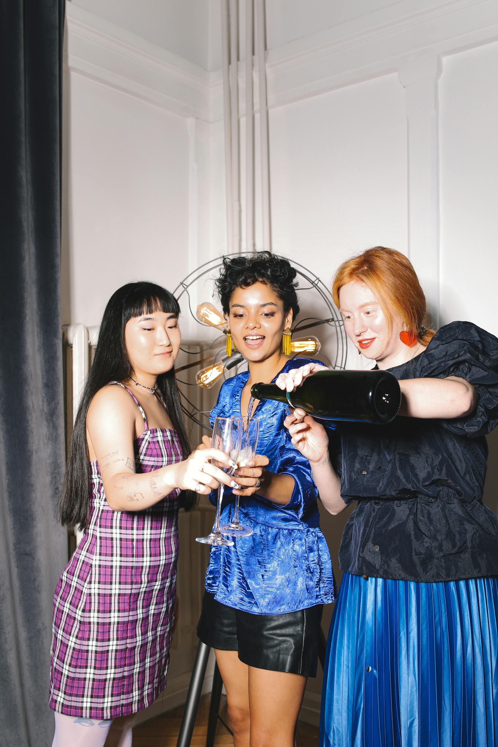 young women celebrating with drinks in their hands