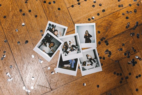 Top View of Instant Photos on a Wooden Floor