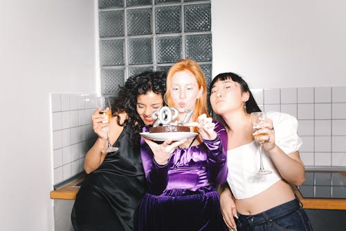 Young Women Celebrate New Year with Chocolate Cake and Champagne
