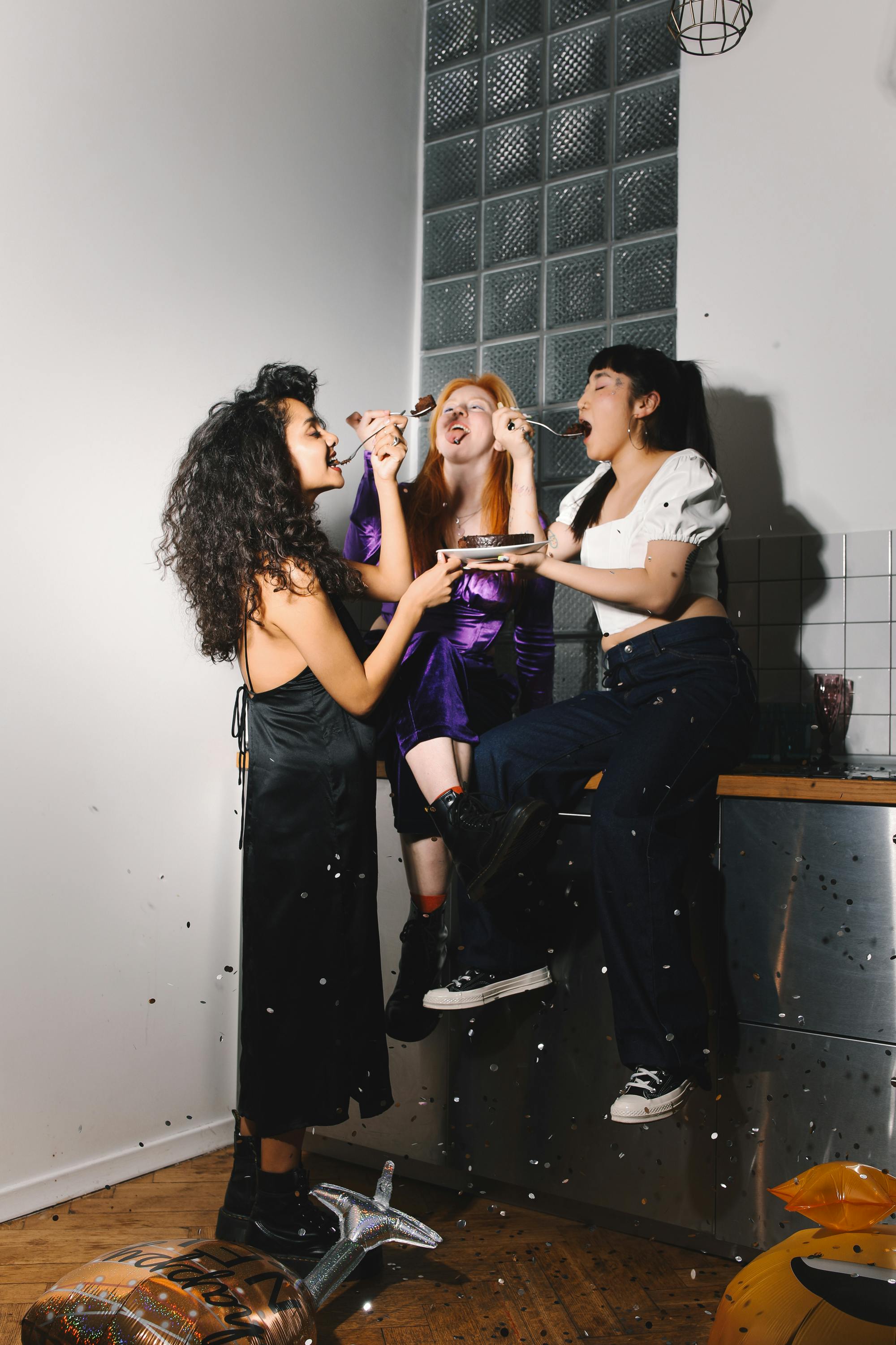 women sharing chocolate cake