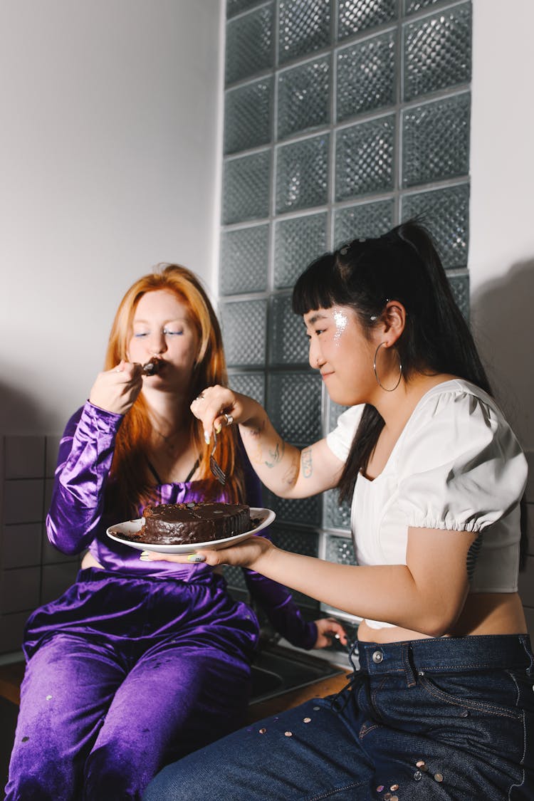 Women Eating A Chocolate Cake