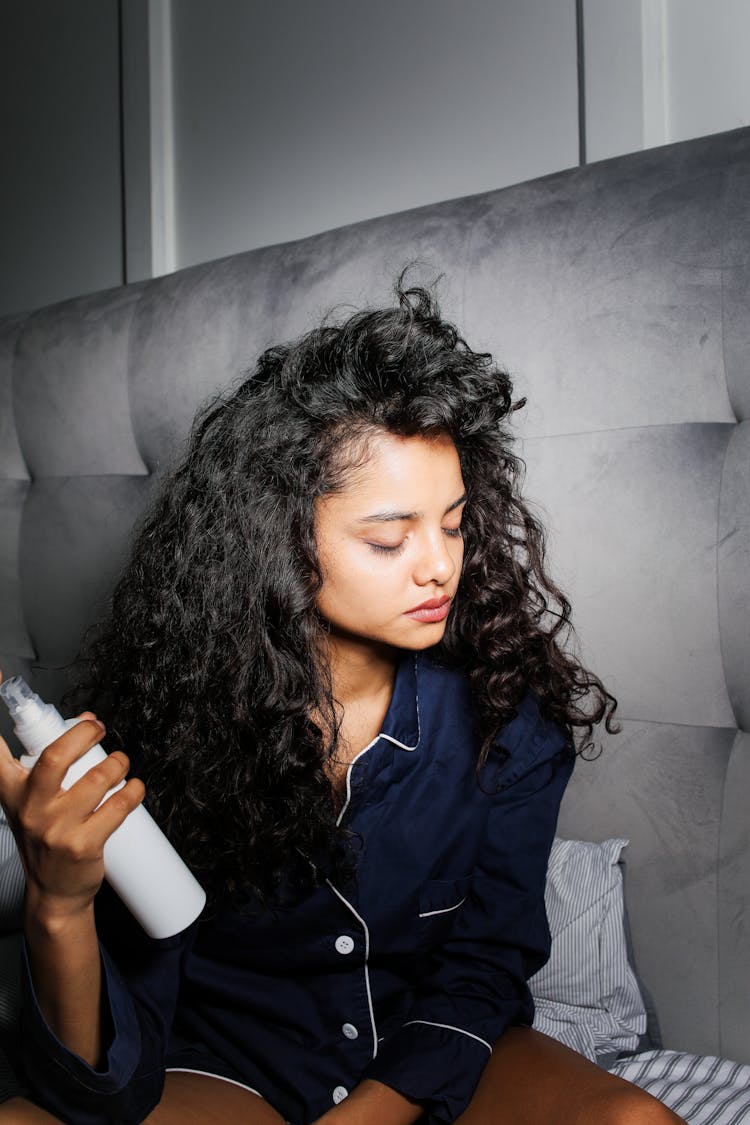 A Woman Holding Spray Bottle