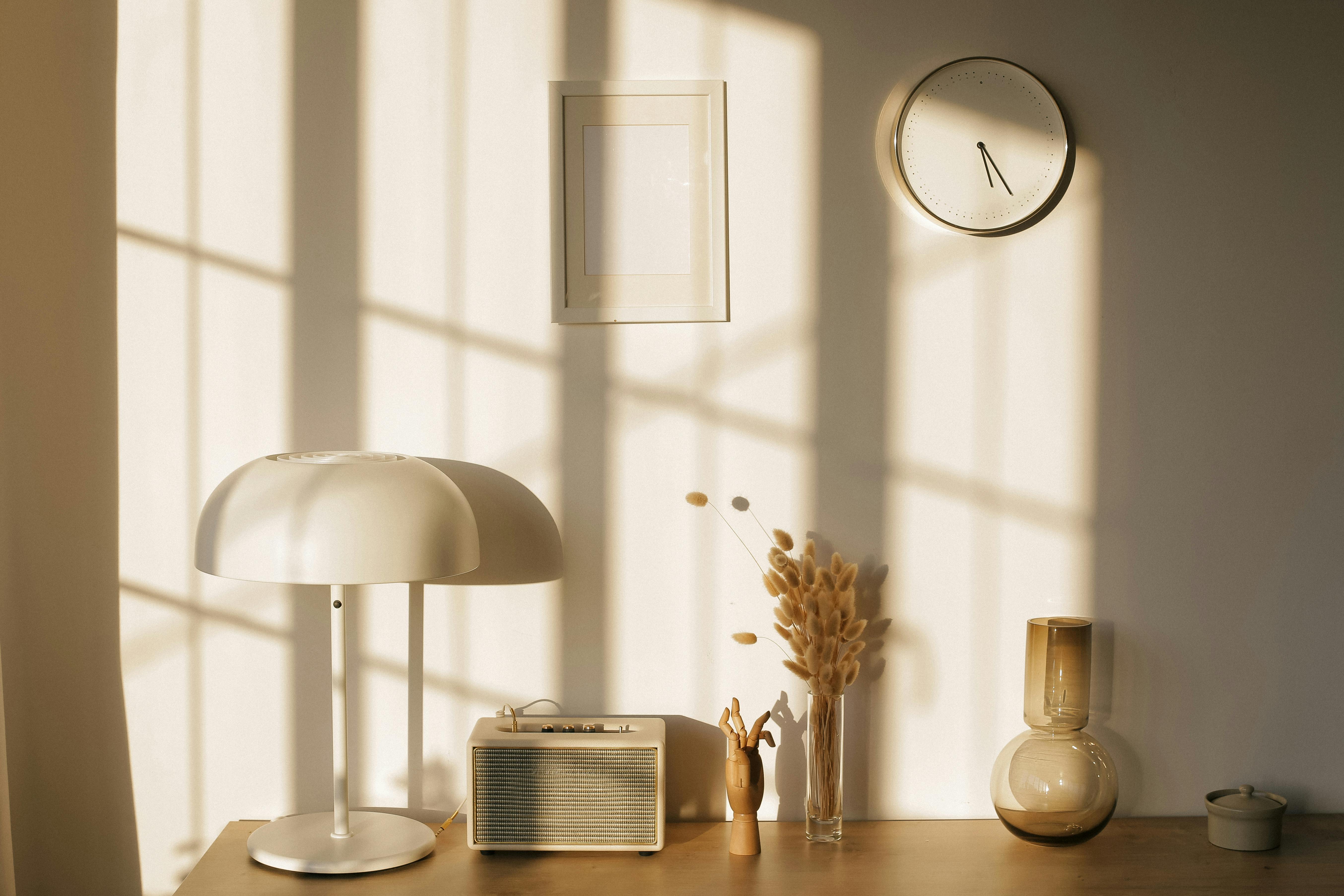 room interior with lamp and vases on table near wall