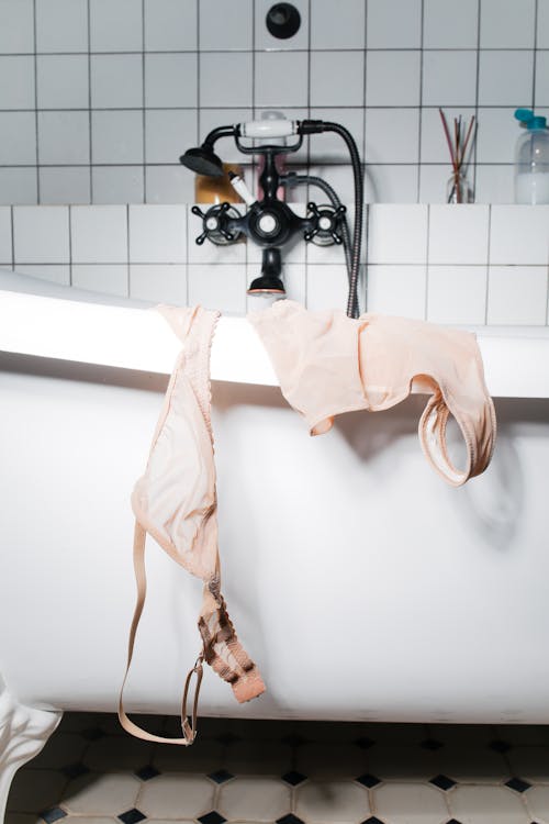 Free Underwear Hung on the Side of the Bathtub Stock Photo