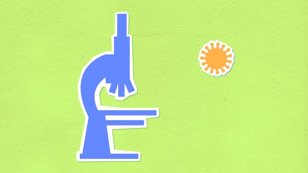Decorative cardboard illustration of microscope with virus on green background