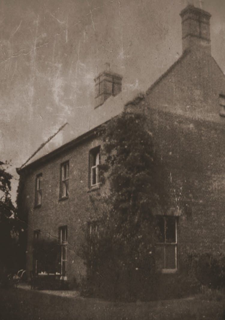 Grayscale Photo Of Concrete House With Chimneys