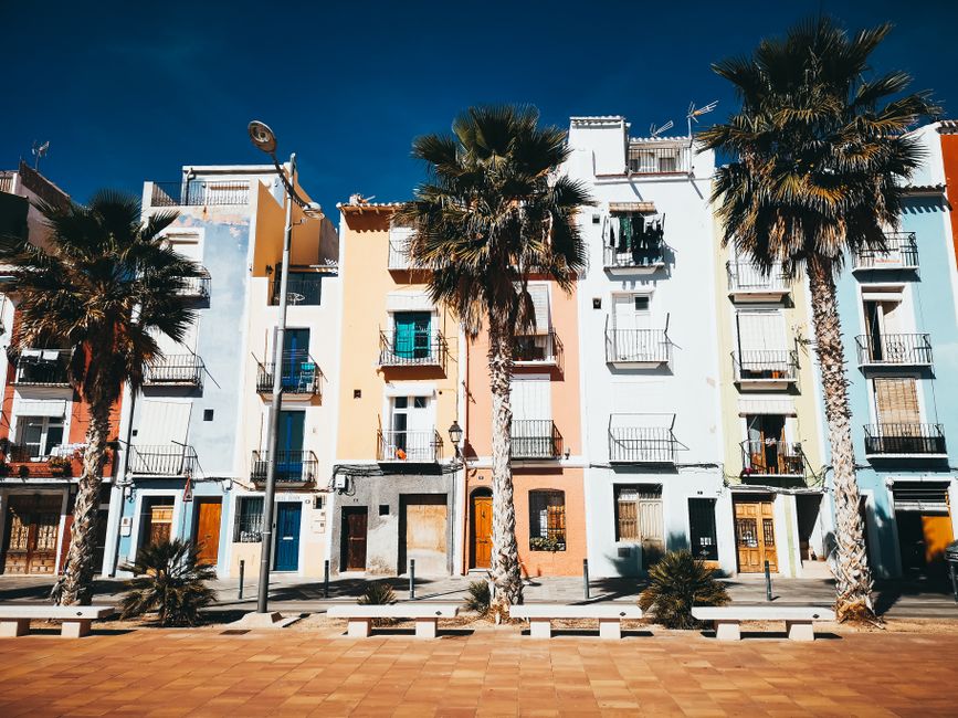 Sunny Spanish street with palm trees and colourful buildings - emigrating to spain Sunny Spanish street with palm trees and colourful buildings - emigrating to spain