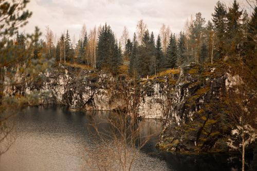 Free Scenic autumn landscape with cliffs and trees reflecting in a tranquil lake. Stock Photo