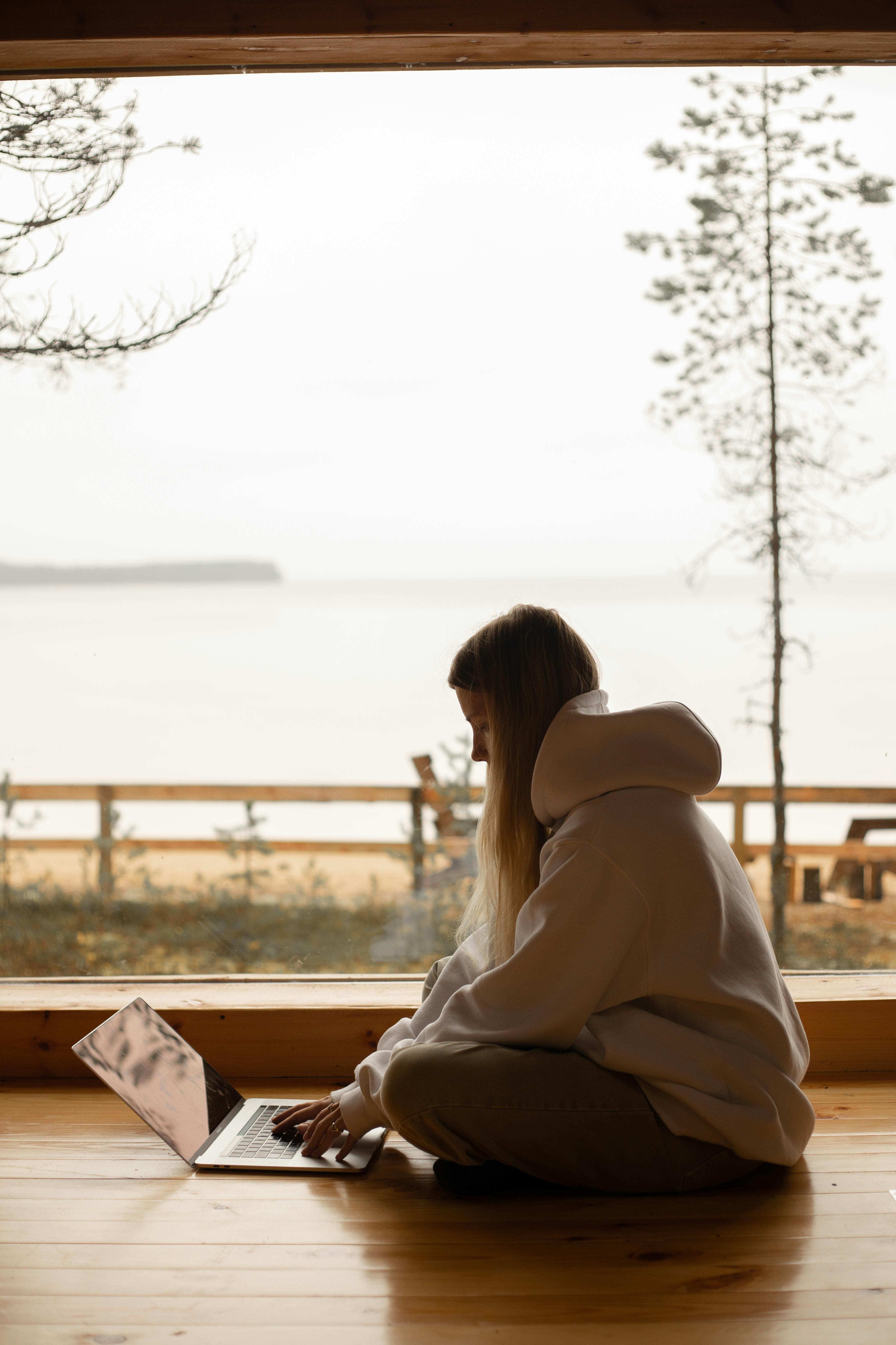 young woman sitting on the floor and using laptop