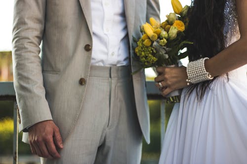 Free Woman Wearing White Dress And Holding Bouquet Stock Photo