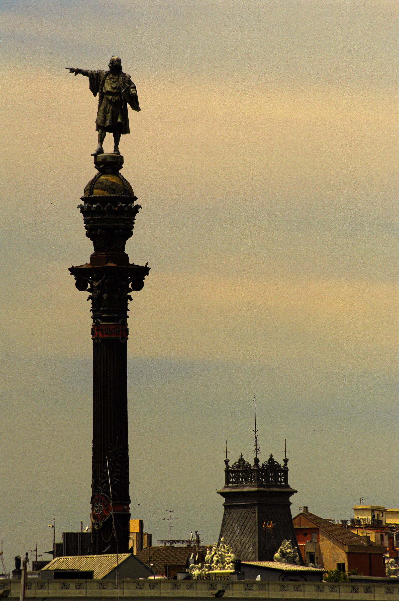 Barcelona skyline at sunset with Columbus monument and Torre Agbar