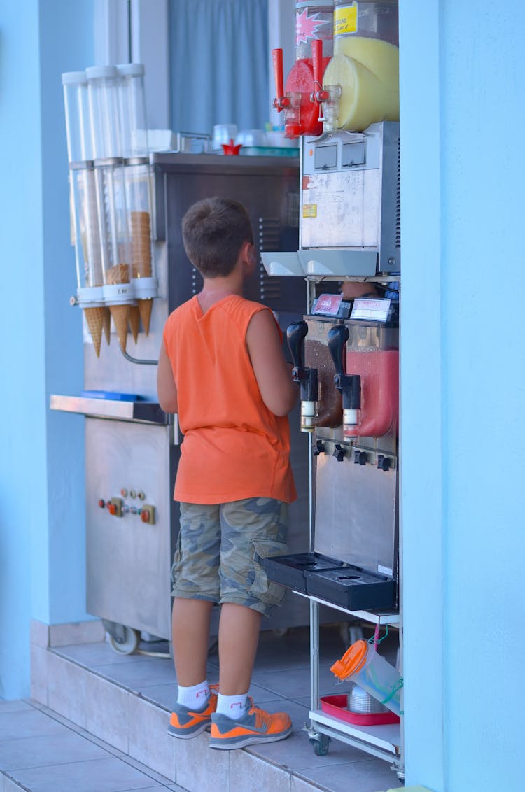 Back View Of Boy Buying Ice Cream