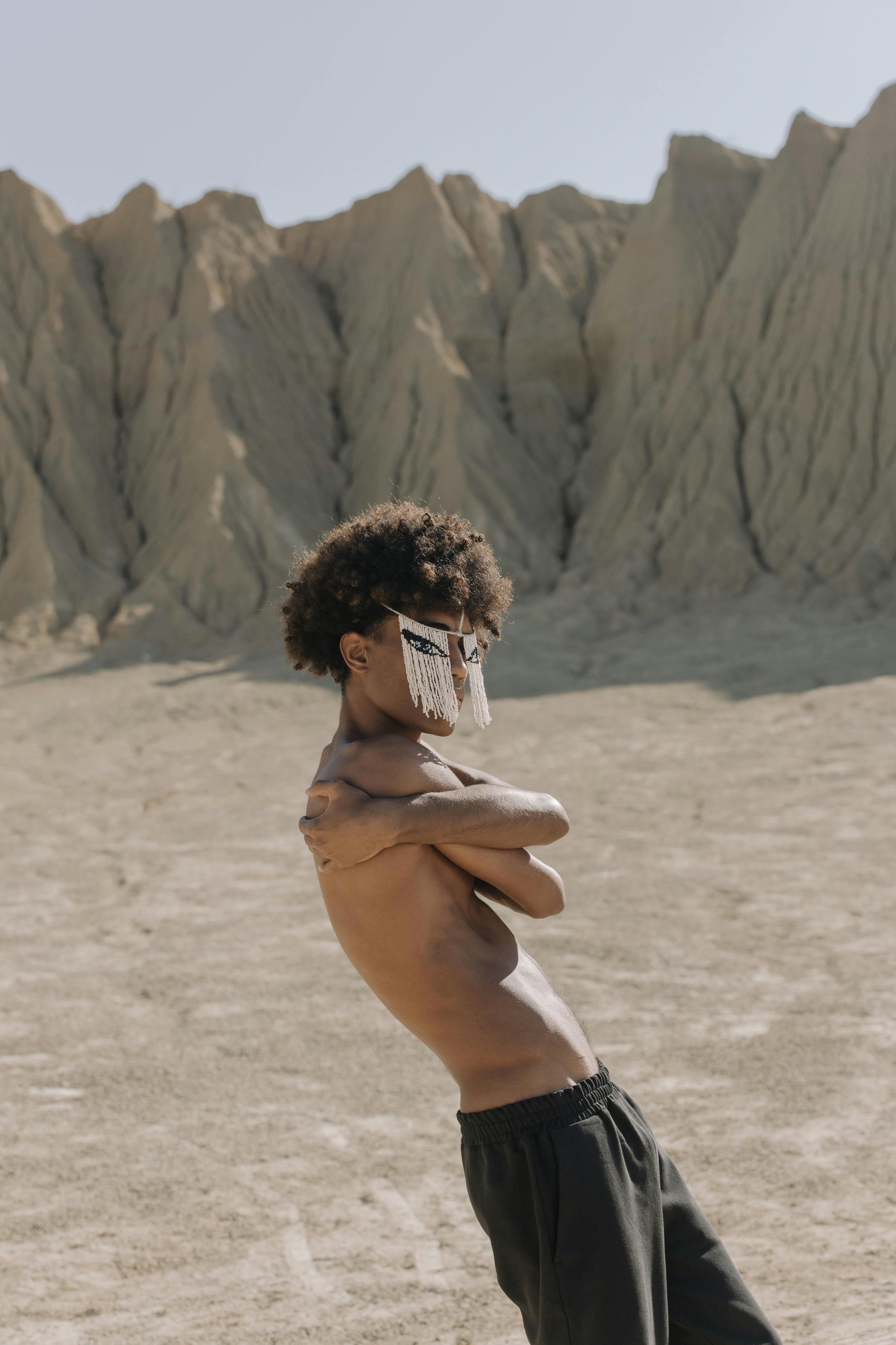 Shirtless Man with Face Mask Standing on Desert · Free Stock Photo