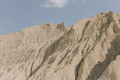 Free Stunning sandstone cliffs showcasing natural erosion under a clear blue sky. Stock Photo