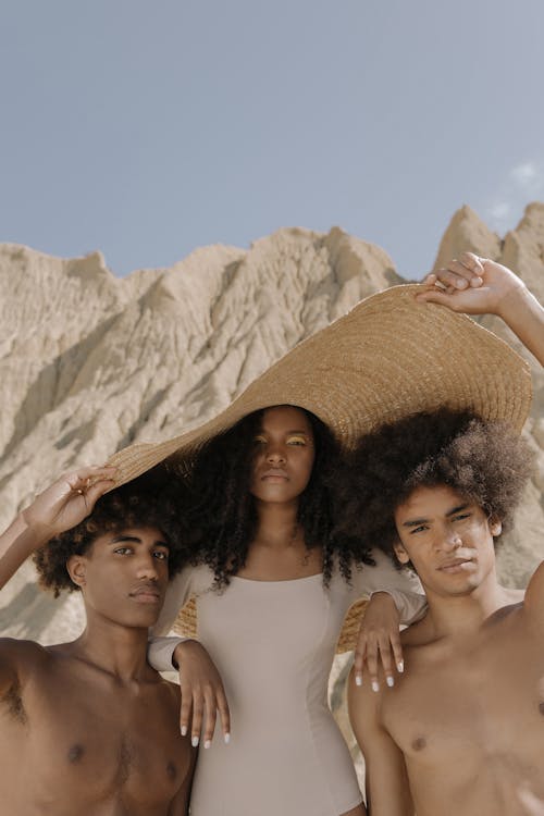 Free Two Men and a Woman Under a Big Hat Stock Photo