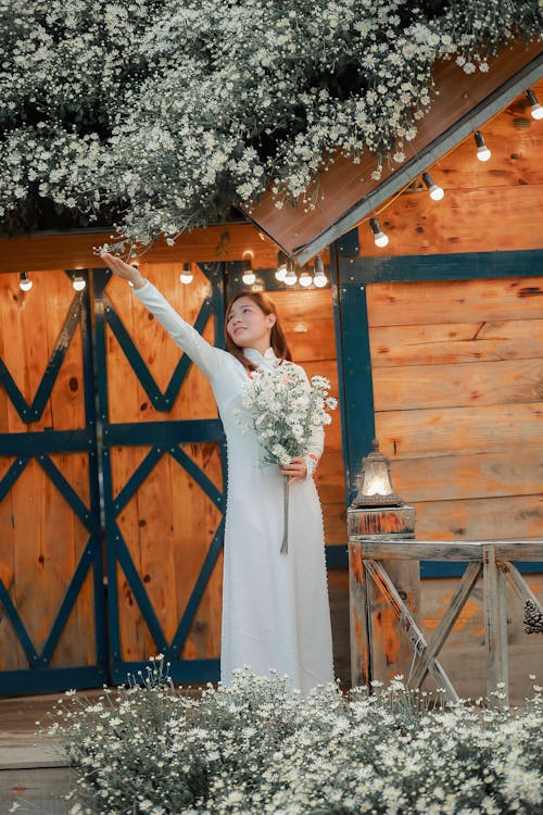 Portrait of Woman in White Dress with Bouquet