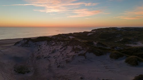 Free Beach and a Sea at Sunset  Stock Photo