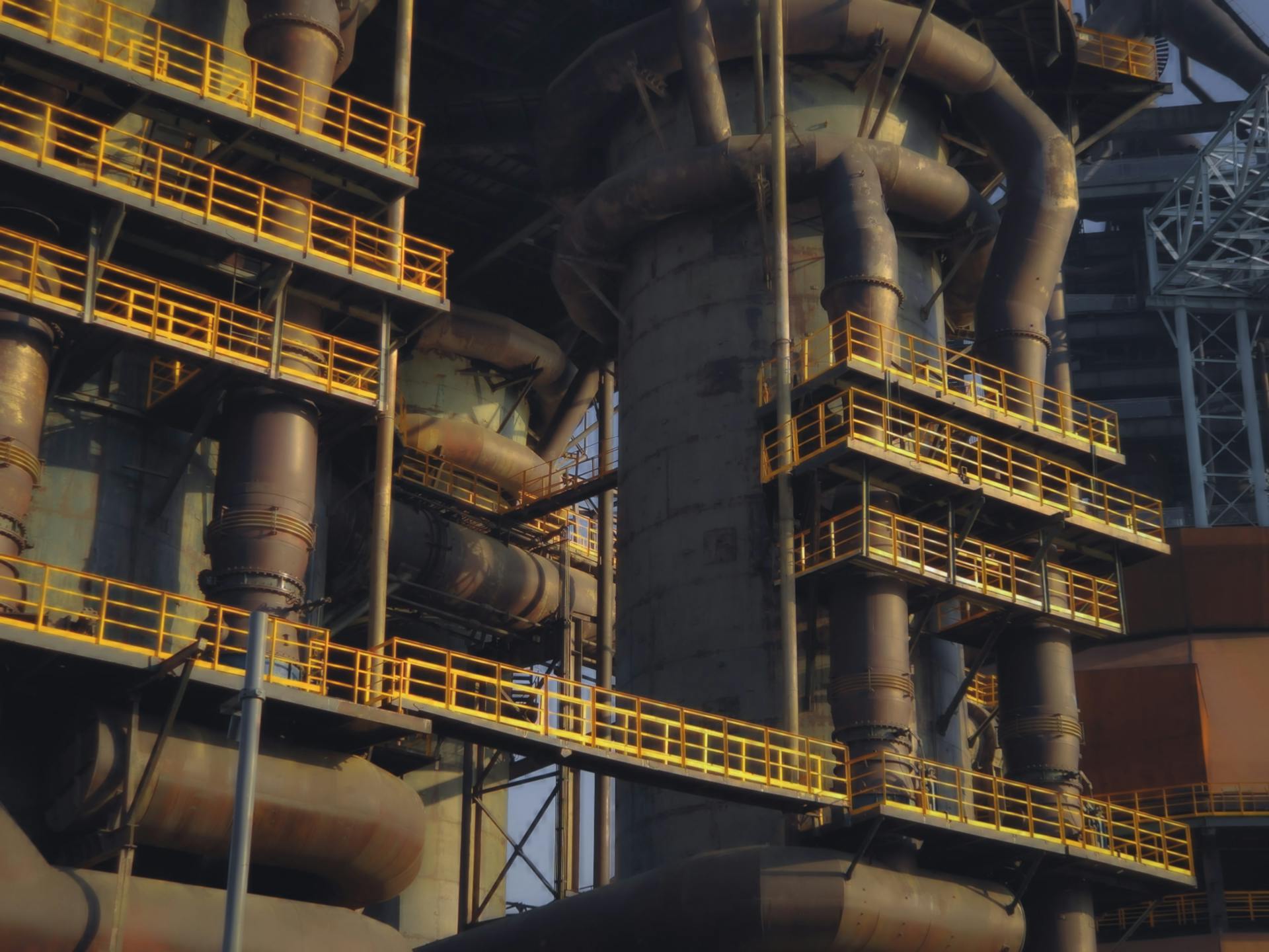 Close-up of an industrial metal structure with pipes and yellow railings in Beijing, China.