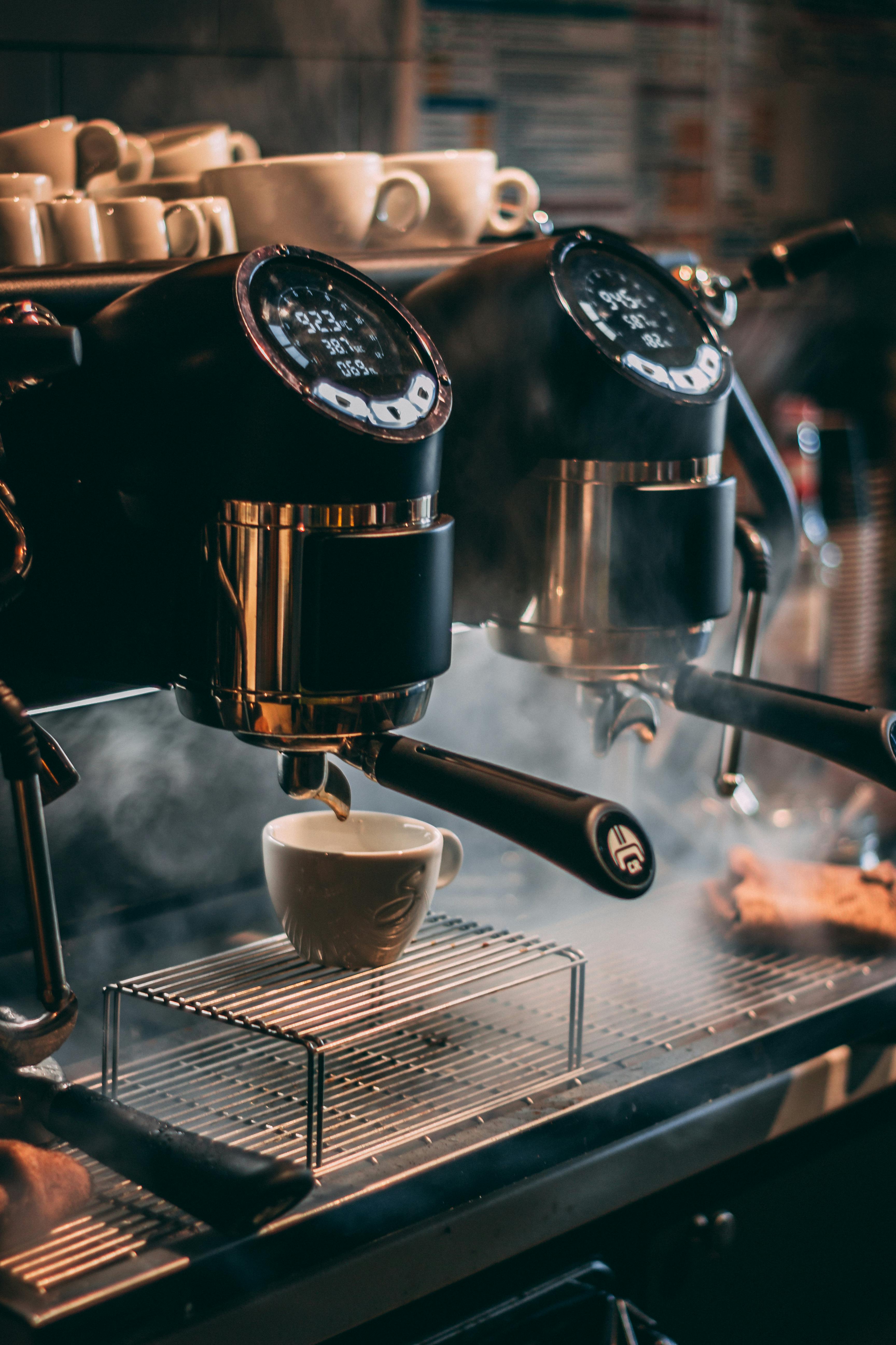 A Steaming Hot Coffee Pouring Out from a Coffee Machine to a Cup · Free ...