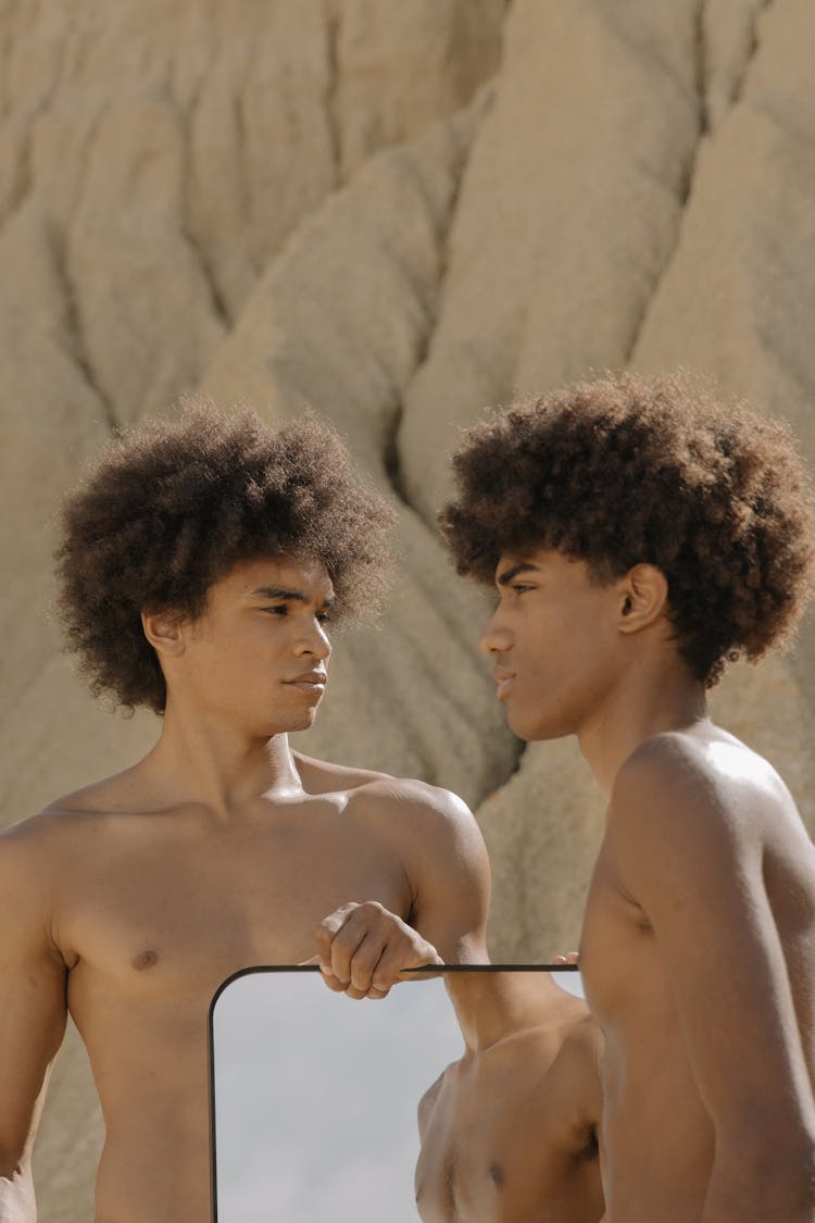 Shirtless Young Men Holding A Mirror