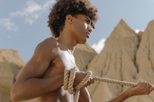 Topless Man Holding a Rope