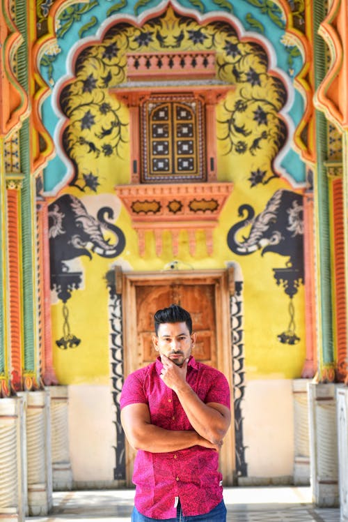 Man in Pink Polo With Hand on Chin 