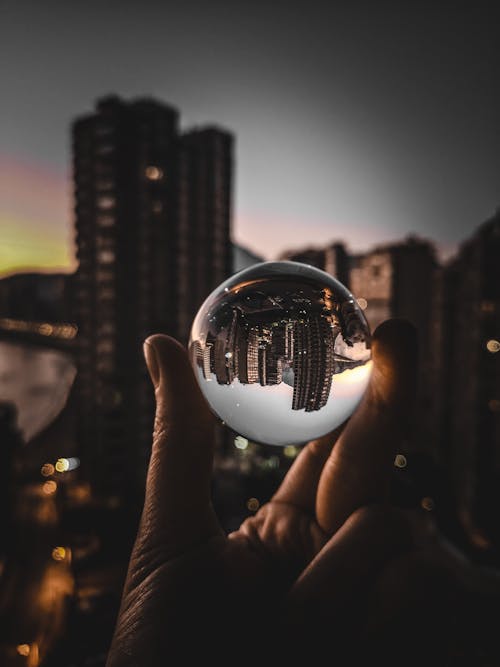 A Person Holding a Clear Glass Ball