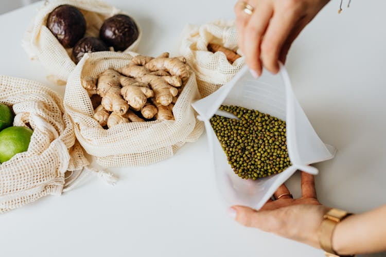 Hands Holding An Open Bag With Beans