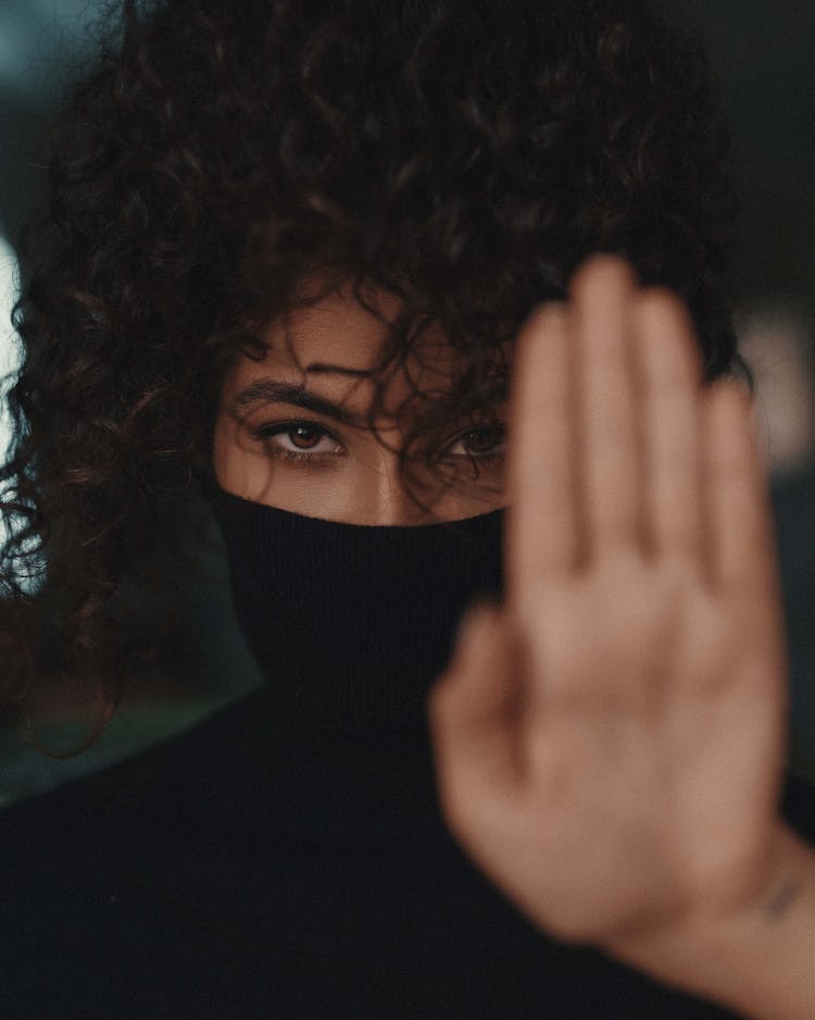 Woman Covering Face With Her Turtleneck Shirt