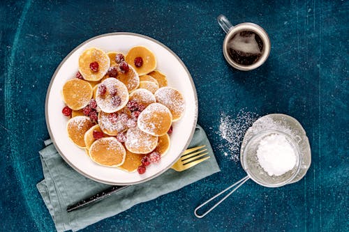 Free Mini Pancakes with Fresh Raspberries on a Plate Stock Photo