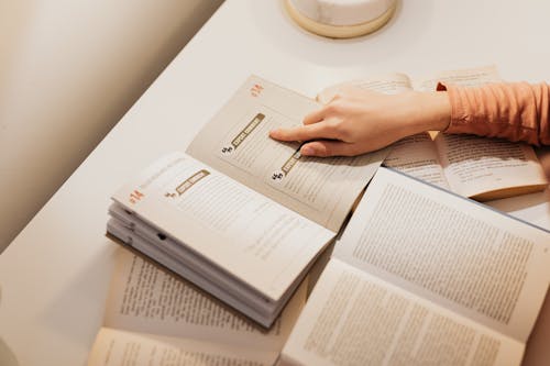 Free Hand Pointing at Text in a Book Stock Photo