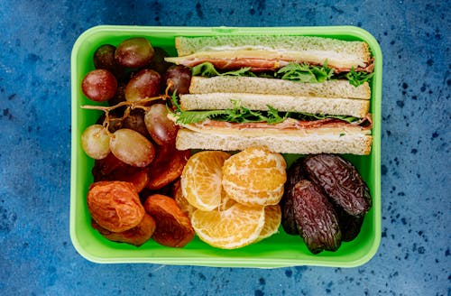 Free Lunch Box with Sandwiches and Fruit Stock Photo