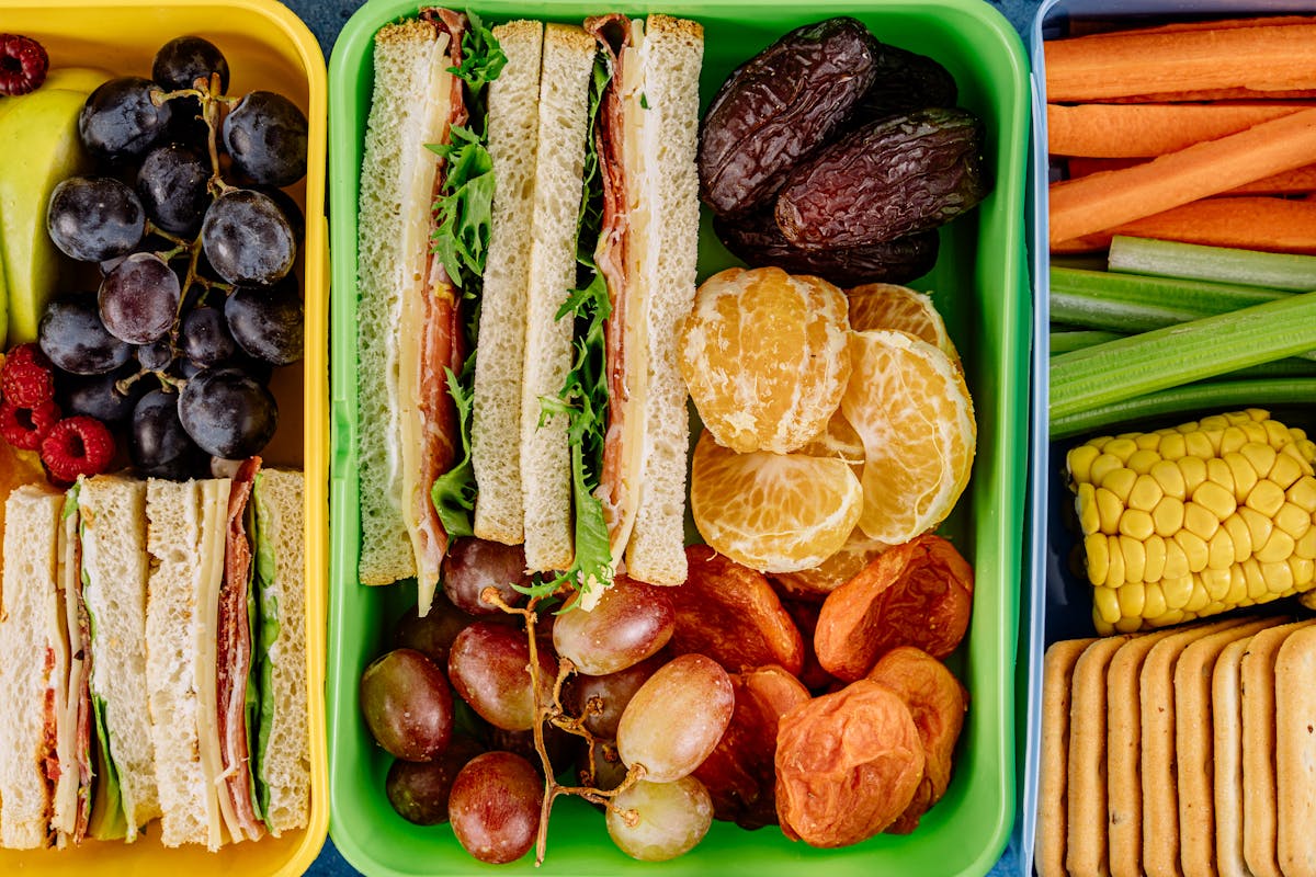 Contenitore per pranzo con frutta e verdure disposte ordinatamente